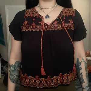 black blouse with orange embroidery